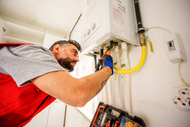 Middle-aged, bearded  man repair gas boiler with wrenches, Gas Heating Boiler Service At Home